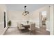 Dining room with chandelier and view into kitchen at 7972 Snowberry Cir, Orlando, FL 32819