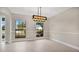 Bright dining room with large windows and a chandelier at 7972 Snowberry Cir, Orlando, FL 32819