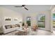 Living room with ceiling fan and access to backyard at 7972 Snowberry Cir, Orlando, FL 32819