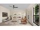 Living Room with ceiling fan and large windows at 7972 Snowberry Cir, Orlando, FL 32819