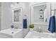 Bathroom featuring dual sinks and framed mirrors, accented with blue towels and plants at 107 Hickory Tree Rd, Longwood, FL 32750