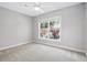 Bright bedroom with neutral paint and carpet with a large window view at 4878 Conway Rd # 91, Orlando, FL 32812