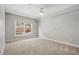 Neutral bedroom with large window and neutral carpet at 4878 Conway Rd # 91, Orlando, FL 32812