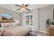 Cozy bedroom featuring a ceiling fan, a large window, and neutral décor and a comfortable queen size bed at 4878 Conway Rd # 91, Orlando, FL 32812