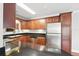 Kitchen featuring dark countertops and wood cabinetry, complete with stainless steel appliances at 4878 Conway Rd # 91, Orlando, FL 32812