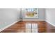 Inviting living space with hardwood floors and a large window offering ample natural light at 4878 Conway Rd # 91, Orlando, FL 32812