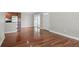 Open-concept living area with gleaming hardwood floors, neutral paint and bright natural light at 4878 Conway Rd # 91, Orlando, FL 32812