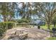 Inviting outdoor area with picnic tables, benches, lush landscaping, and mature trees at 4878 Conway Rd # 91, Orlando, FL 32812