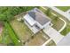 Aerial view of the residence, showing solar panels, fenced yard, and extended driveway at 2479 Vaughn Ave, Deltona, FL 32725