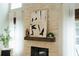 Close up of the stone fireplace and mantle with art displayed above at 70 Millholland St, Oakland, FL 34760