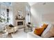 Bright living room with stone fireplace and neutral furniture at 70 Millholland St, Oakland, FL 34760