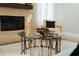 Cozy living room with glass coffee table and a stone fireplace at 70 Millholland St, Oakland, FL 34760