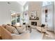 Bright living room with a stone fireplace, large windows and comfortable seating at 70 Millholland St, Oakland, FL 34760