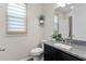 Well-lit bathroom with granite countertop, a toilet, and a shower at 10204 Spring Lake Dr, Clermont, FL 34711