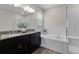 Elegant bathroom showcasing double sinks, a soaking tub, and a separate glass-enclosed shower with modern fixtures at 10204 Spring Lake Dr, Clermont, FL 34711