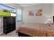 Nicely decorated bedroom featuring a television and colorful artwork at 10204 Spring Lake Dr, Clermont, FL 34711