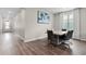 Dining room area with a modern table and chairs with a view of the front door at 10204 Spring Lake Dr, Clermont, FL 34711