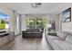 Comfortable living room featuring neutral tones, plush seating, and large sliding doors opening to the outdoors at 10204 Spring Lake Dr, Clermont, FL 34711