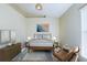 Bedroom with wood-like flooring and window; staged at 13136 S Ashington Pointe Dr, Orlando, FL 32824