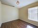 Empty bedroom with laminate wood flooring and window at 13136 S Ashington Pointe Dr, Orlando, FL 32824