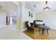 Living room with tiled floor, seating area, and view into the dining area at 13136 S Ashington Pointe Dr, Orlando, FL 32824