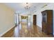 Living room with hardwood floors and a view into the kitchen and dining area at 13136 S Ashington Pointe Dr, Orlando, FL 32824