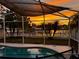 Sunset view from a screened pool area at 13136 S Ashington Pointe Dr, Orlando, FL 32824