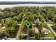 Aerial view of home nestled in a wooded neighborhood near the lake at 14315 Conifer Dr, Orlando, FL 32832