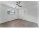 Simple bedroom with wood-look floors and built-in shelving at 14315 Conifer Dr, Orlando, FL 32832