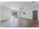 Bedroom with wood-look floors and sliding glass doors to backyard at 14315 Conifer Dr, Orlando, FL 32832