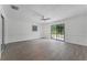 Spacious bedroom with hardwood floors and sliding glass doors at 14315 Conifer Dr, Orlando, FL 32832