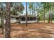 Back of house with screened porch and wooded backyard at 14315 Conifer Dr, Orlando, FL 32832