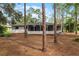 Back of house with screened porch and wooded backyard at 14315 Conifer Dr, Orlando, FL 32832