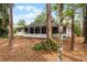 Back of house with screened porch and wooded backyard at 14315 Conifer Dr, Orlando, FL 32832