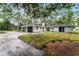 Ranch style home with a black garage door and walkway at 14315 Conifer Dr, Orlando, FL 32832