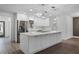 Bright white kitchen featuring a spacious island and stainless steel appliances at 14315 Conifer Dr, Orlando, FL 32832