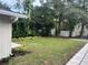 Landscaped side yard with lush green grass and plants at 14315 Conifer Dr, Orlando, FL 32832