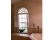 Bathroom featuring soaking tub with window, accent wall, and candle decor at 2717 Bayview Dr, Eustis, FL 32726