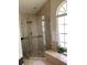 Spacious tiled shower with glass door and window at 2717 Bayview Dr, Eustis, FL 32726