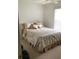 Cozy bedroom featuring plush bedding, a ceiling fan and soft natural light at 2717 Bayview Dr, Eustis, FL 32726