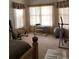 Spacious bedroom with exercise equipment, natural light, and neutral walls at 2717 Bayview Dr, Eustis, FL 32726