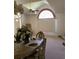 Bright dining room featuring an arched window, chandelier, and neutral color palette at 2717 Bayview Dr, Eustis, FL 32726