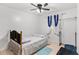 Simple bedroom with ceiling fan and neutral-colored bedding at 1788 N Hiawassee Rd, Orlando, FL 32818