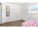 Small bedroom with wood flooring, a bed, and a mirrored wall at 1788 N Hiawassee Rd, Orlando, FL 32818