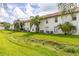 Exterior view of the backyard with well-maintained lawn and mature landscaping at 3651 N Goldenrod Rd # 204, Winter Park, FL 32792