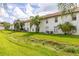 Exterior view of the backyard with well-maintained lawn and mature landscaping at 3651 N Goldenrod Rd # 204, Winter Park, FL 32792