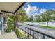 View from a condo balcony overlooking the parking area, and surrounding trees at 3651 N Goldenrod Rd # 204, Winter Park, FL 32792