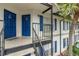 View of condo exterior with blue doors and shutters, accessible by outdoor staircase at 3651 N Goldenrod Rd # 204, Winter Park, FL 32792