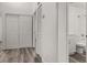 Hallway area with closet and view of a full bathroom with modern updates at 3651 N Goldenrod Rd # 204, Winter Park, FL 32792