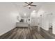 Open-concept living room and kitchen area with ceiling fan and wood-look vinyl plank flooring at 3651 N Goldenrod Rd # 204, Winter Park, FL 32792